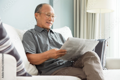 senior man reading newspaper.
