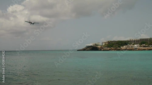 Airplane is overflowing sea shore of Maho Beach
