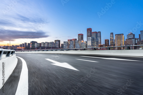 panoramic city skyline with empty asphalt road © THINK b