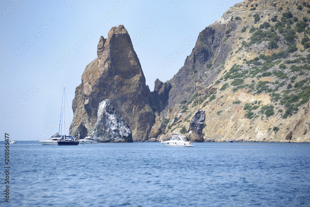 View from the mountain to the rocky seashore with yachts.