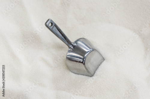 white granulated sugar. shovel. abstract texture of crystals for a background from minerals of white color © jollier_