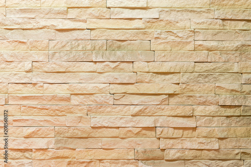 Wall made of decorative light brown stone. Decorating for the fireplace. Background
