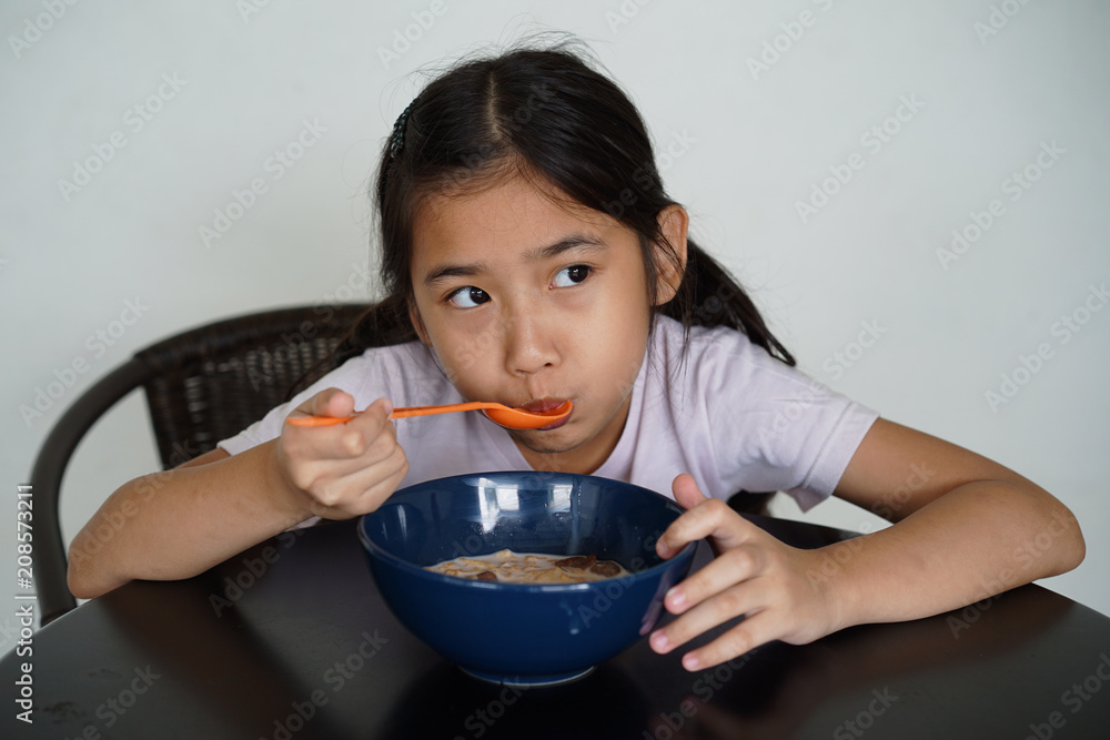 Asian kids little girl Eating breakfast corn flake and milk Asian kids little girl Eating breakfast corn flake and milk