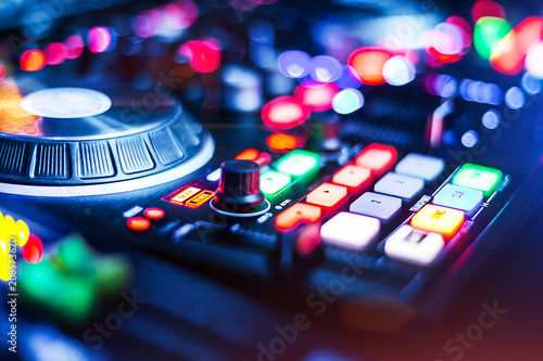 lightened Audio Control Panel with adjusted slide bar for DJ in night club. DJ professional sound mixer technology. Buttons and tabs of the audio controller for disk jockey