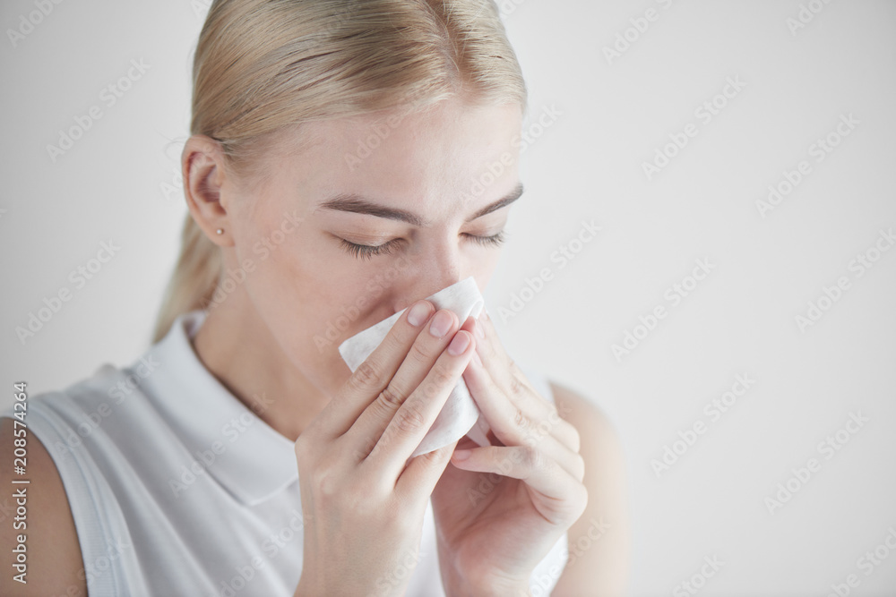 Rhinitis. Girl with napkin on white background Rhinitis. Girl with napkin on white background