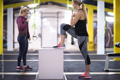 athletes working out jumping on fit box