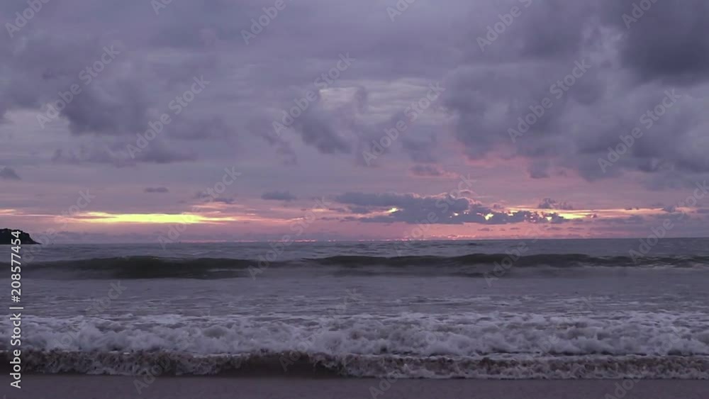 seascape at sunset reflected on wet beach sand with incoming waves. motor boats with parasailing on a horizon seascape at sunset reflected on wet beach sand with incoming waves. motor boats with parasailing on a horizon