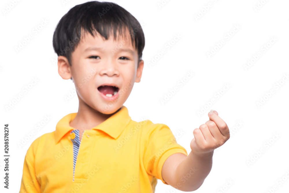 Little asian boy showing his lost milk-tooth in his hand - closeup Little asian boy showing his lost milk-tooth in his hand - closeup