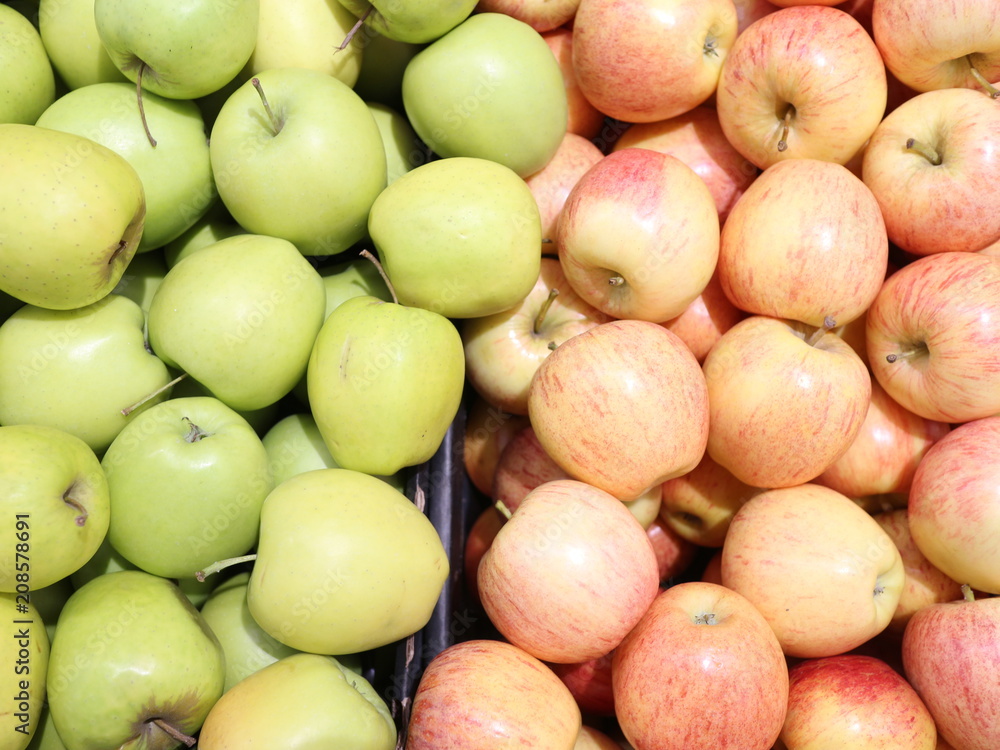 green and red apples in a box