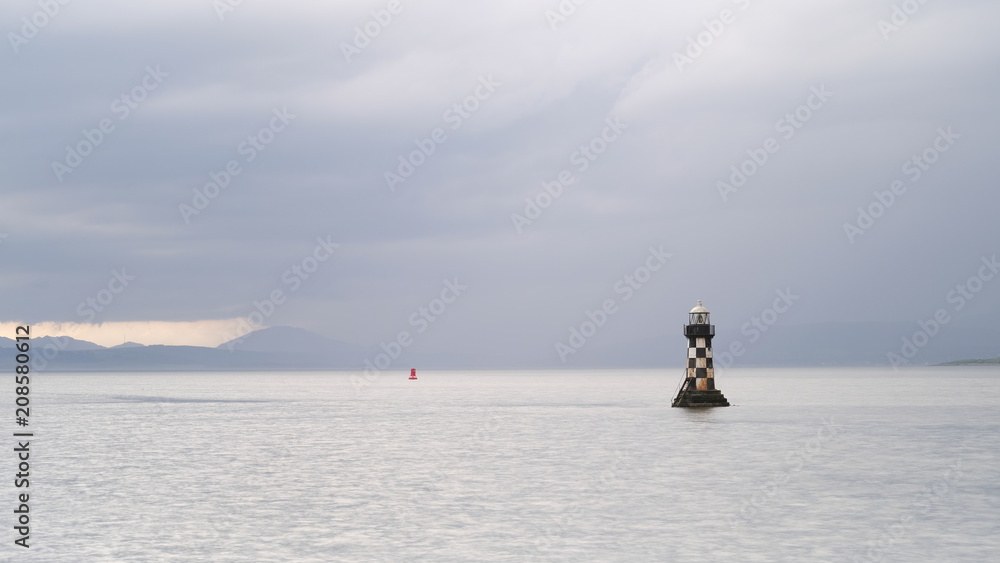 Lighthouse sea storm extreme weather dark sky illuminated ocean mountains outdoors coast uk great britain