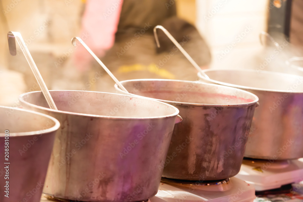 Boiling cauldrons or big pots on street food festival Boiling cauldrons or big pots on street food festival