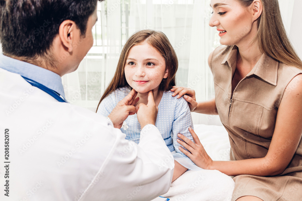 Doctor checking and examination neck pain with little girl child in hospital.healthcare and medicine Doctor checking and examination neck pain with little girl child in hospital.healthcare and medicine