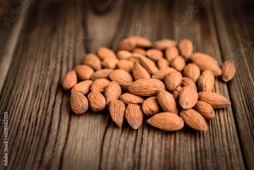 Almond on dark wooden background. Healthy snack.