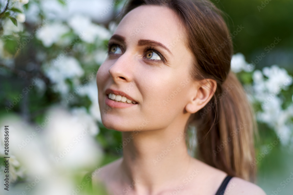 spring girl apple flowers, nature portrait of happy girl with long hair in blooming apple trees, freedom purity concept of happiness