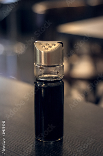 Jar with soy sauce on a wooden table