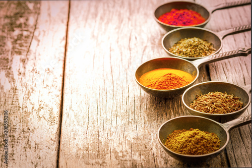 Fototapeta Naklejka Na Ścianę i Meble -  Wooden table of colorful spices.