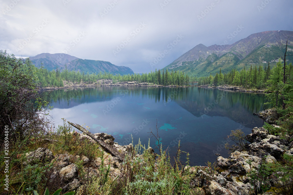 Beautiful summer Landscape with a high-mountain lake. Majestic wild nature in Russia, Eastern Sayan.