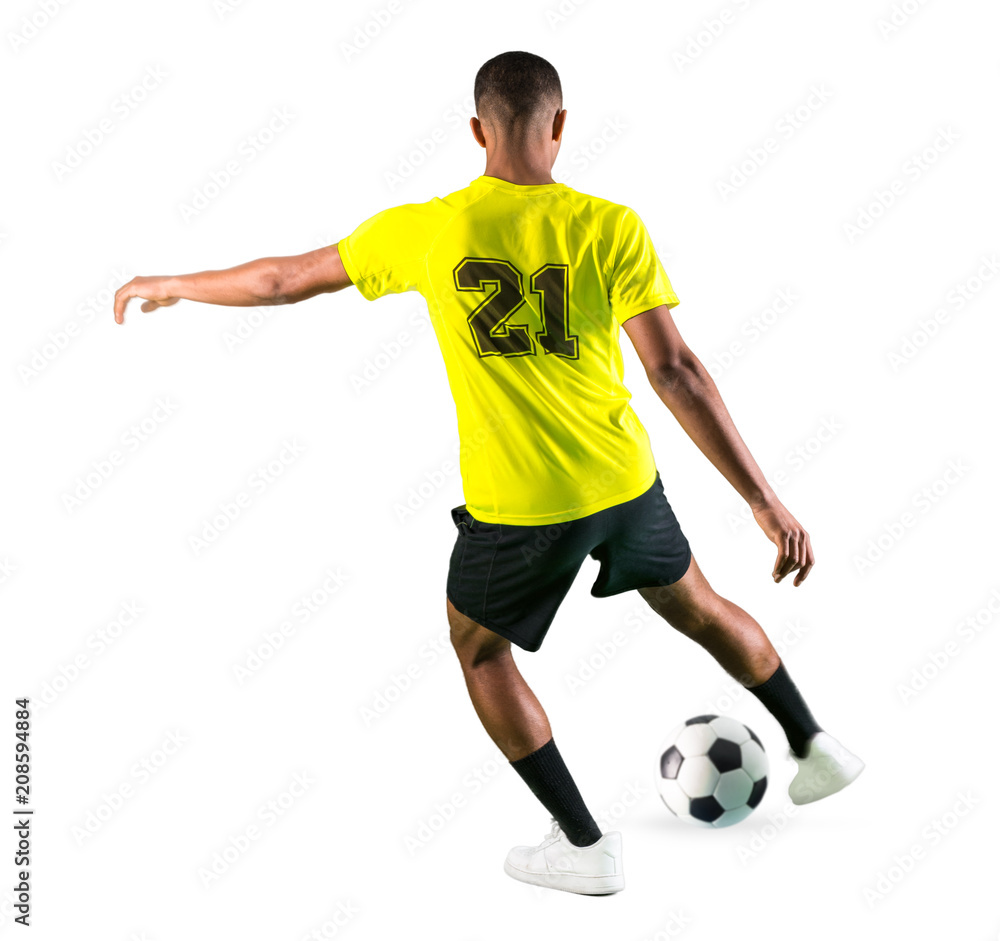 Soccer player man with dark skinned playing kicking the ball