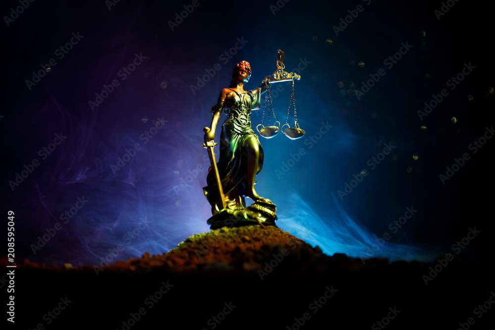 The Statue of Justice - lady justice or Iustitia / Justitia the Roman goddess of Justice on a dark fire background The Statue of Justice - lady justice or Iustitia / Justitia the Roman goddess of Justice on a dark fire background