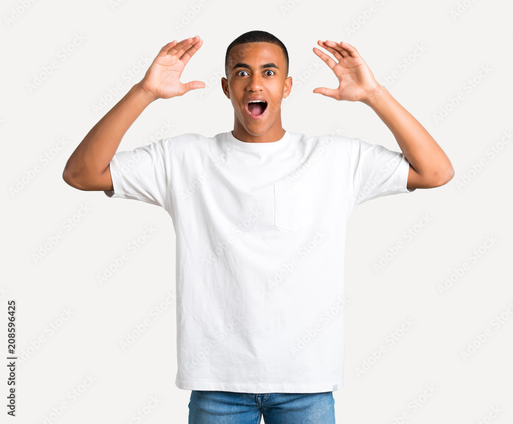 Young african american man with surprise and shocked facial expression. Gaping because can not believe what is happening on isolated background Young african american man with surprise and shocked facial expression. Gaping because can not believe what is happening on isolated background