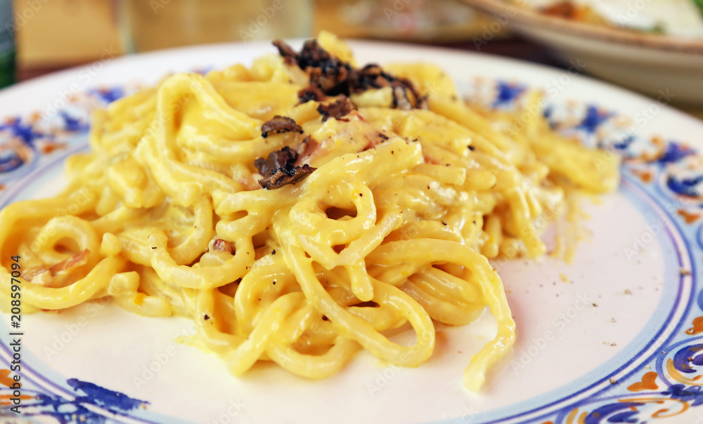 traditional italian dish - spaghetti carbonara with bacon and cream sauce 