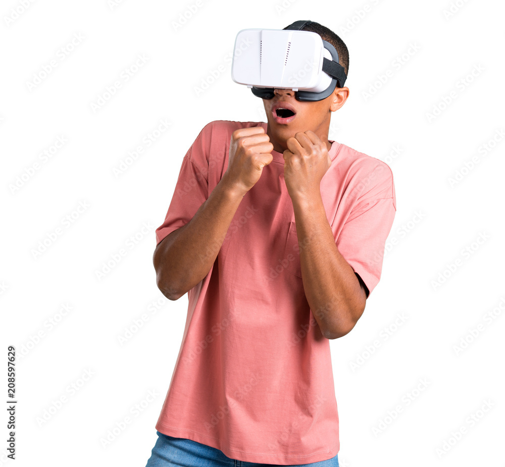 Young african american man using VR glasses. Virtual reality experience on isolated white background Young african american man using VR glasses. Virtual reality experience on isolated white background