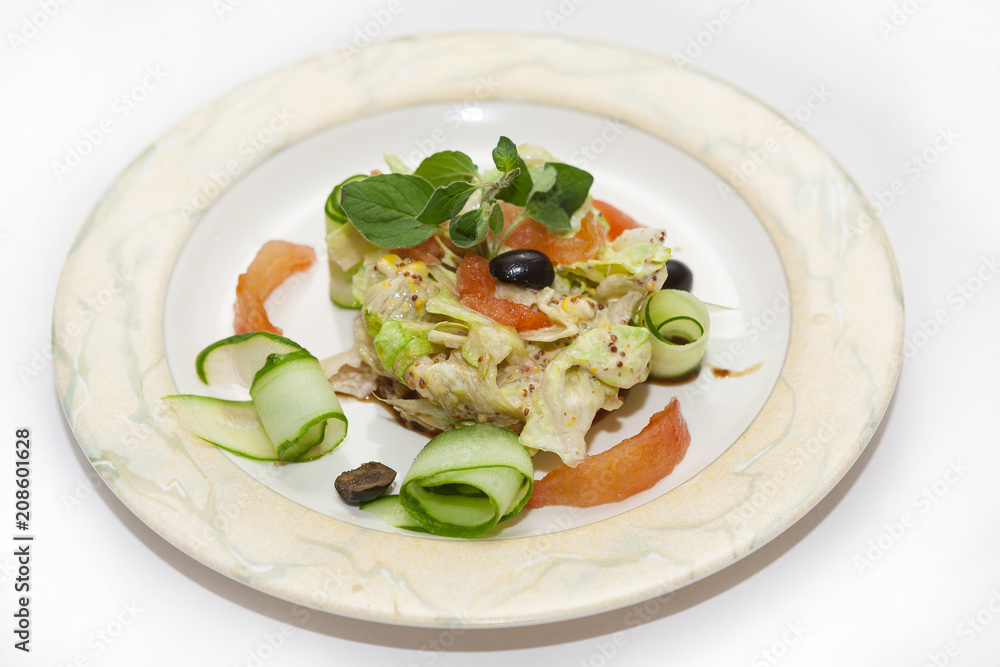 Salad of tomato cucumber and red on the plate. Iaelate on white background Salad of tomato cucumber and red on the plate. Iaelate on white background