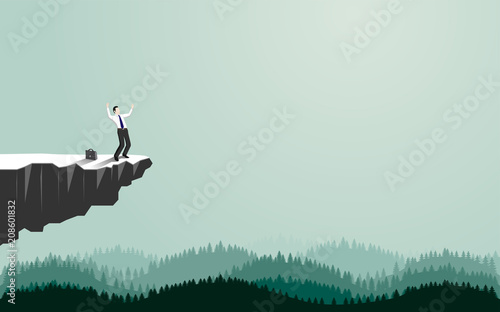 Happy businessman standing on cliff
