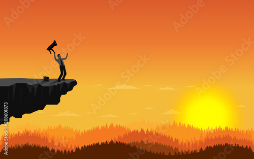 Happy businessman standing on cliff