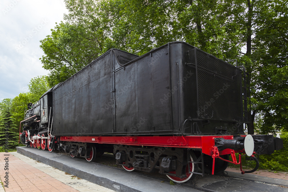 Naklejka premium The locomotive-monument L-3291. Powerful, beautiful Russian locomotive. Wheels close-up. Steam engine.