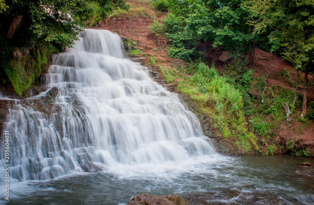 Fototapeta premium Dzhurinsky waterfall - a waterfall on the river Dzhurin in Zaleschitsky district of Ternopil region of Ukraine. The height of the waterfall is 16 meters.