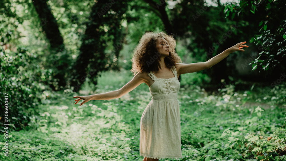 Young and beautiful girl dancing ballet in the secret garden. Natural scenery in the forest. Young and beautiful girl dancing ballet in the secret garden. Natural scenery in the forest.