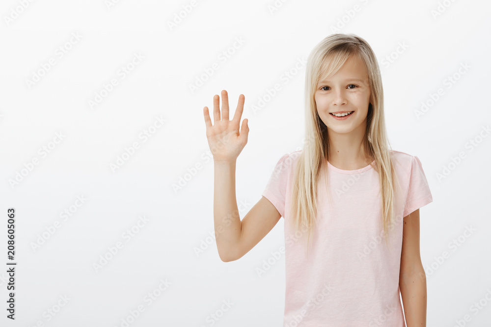 Cute friendly girl meeting new classmates, saying hi and hoping get along. Positive happy female child with blond hair, raising palm in hello gesture, greeting cousine on playground, smiling joyfully Cute friendly girl meeting new classmates, saying hi and hoping get along. Positive happy female child with blond hair, raising palm in hello gesture, greeting cousine on playground, smiling joyfully