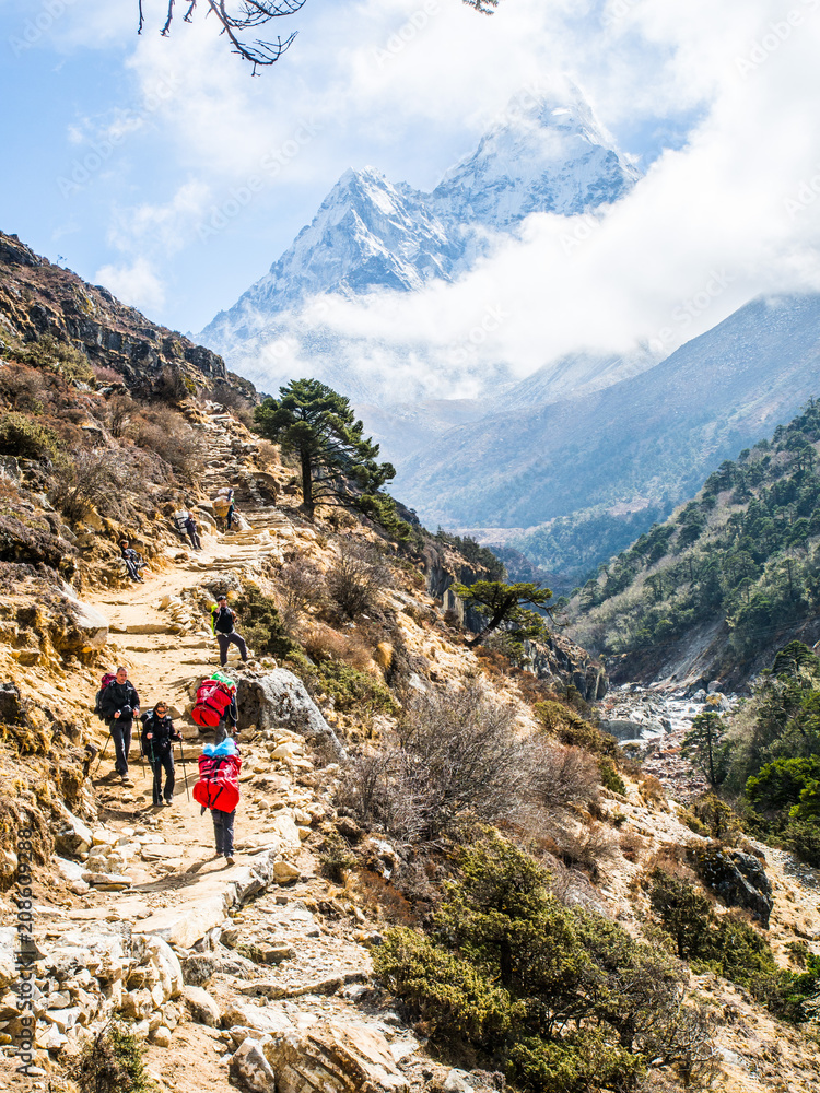 Fototapeta premium Pheriche, Nepal 04/16/2018 : Trekker with the beautiful mountains background