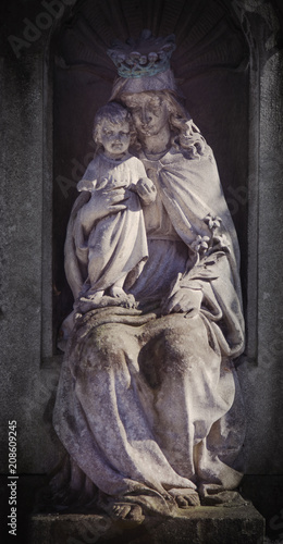 Ancient statue of the Virgin Mary with baby Jesus Christ (religion, faith, Christianity concept)