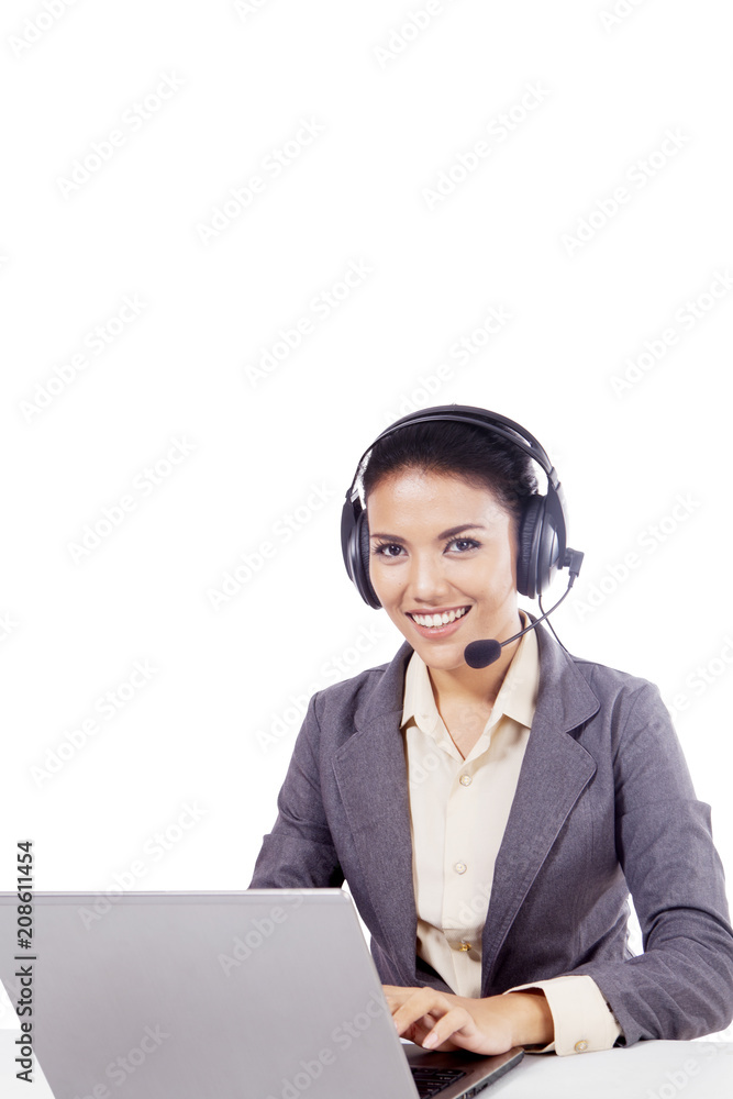 Beautiful call center operator with laptop on studio Beautiful call center operator with laptop on studio