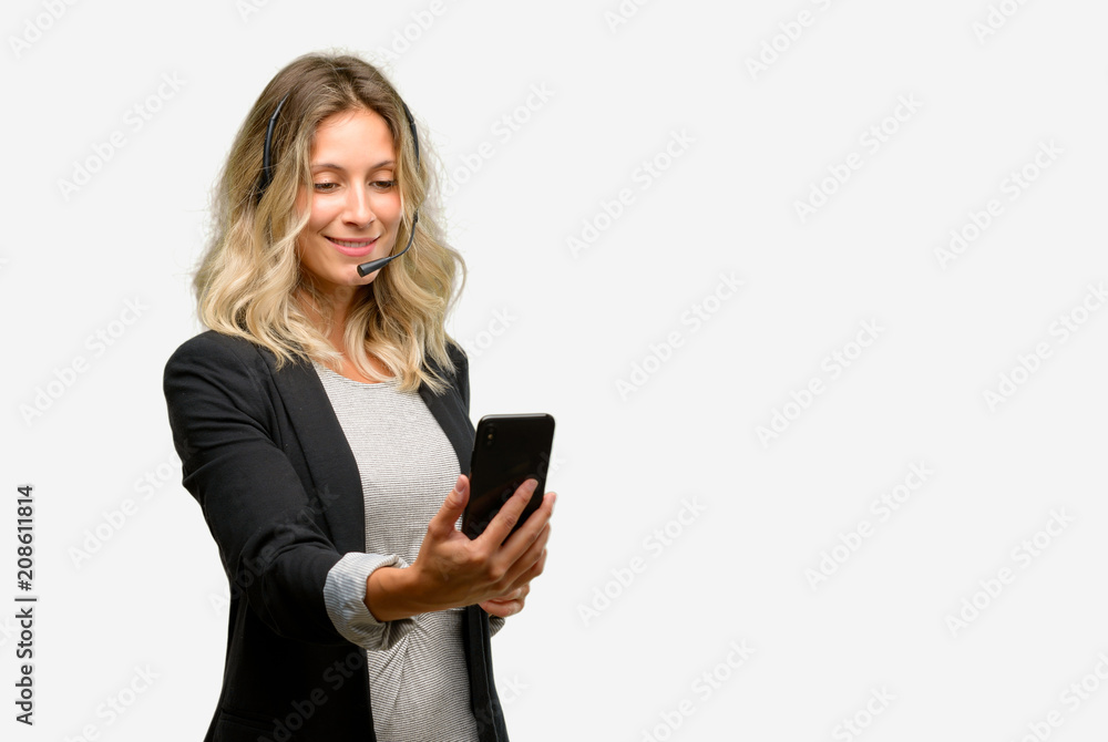 Young woman operator from call center happy talking using a smartphone mobile phone Young woman operator from call center happy talking using a smartphone mobile phone