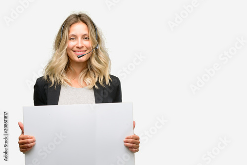 Young woman operator from call center holding blank advertising banner, good poster for ad, offer or announcement, big paper billboard