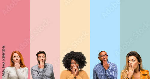 Cool group of people, woman and man covers mouth in shock, looks shy, expressing silence and mistake concepts, scared