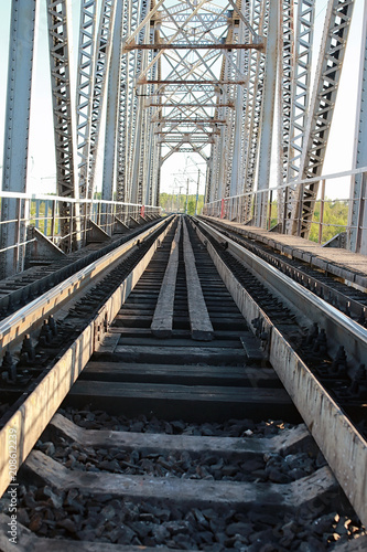 Fototapeta Naklejka Na Ścianę i Meble -  bridge on the railroad tracks and industrial gray stone