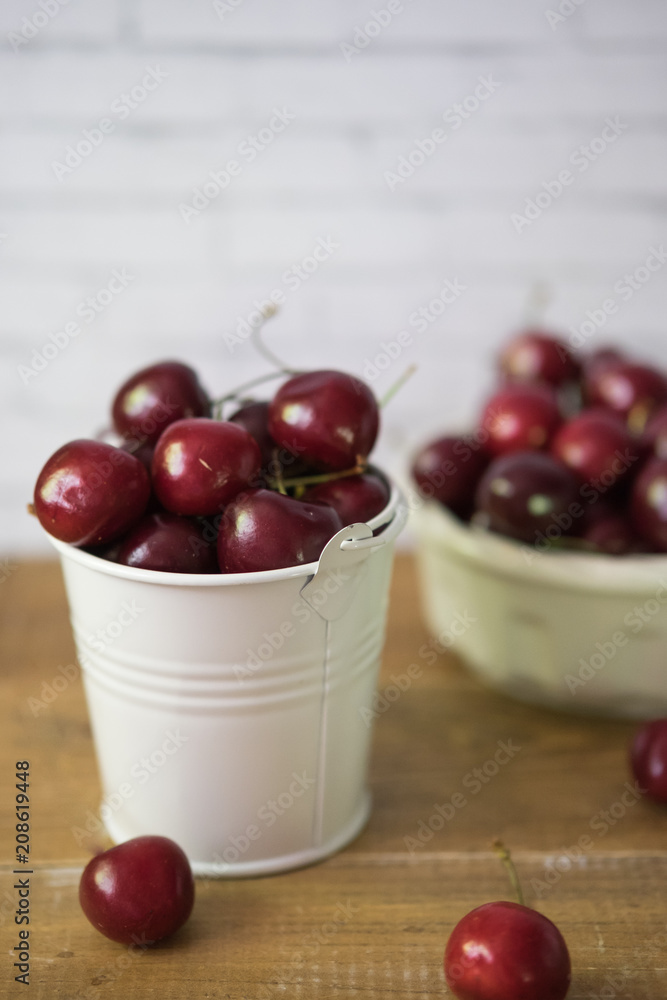 Cherries in a bowl on a wooden table Cherries in a bowl on a wooden table
