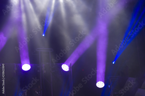 Soffits during  concert, robots letting blue rays on a professional dark scene