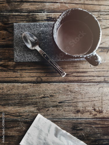 Wallpaper Mural Cup of coffee with teaspoon and paper napkin on wooden table  with warm light Torontodigital.ca