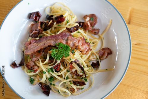 Delicious spaghetti with bacon on wooden table
