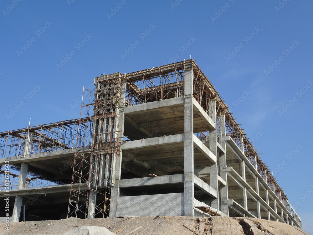 Obraz premium Building reinforcement concrete structure at the construction site. Post, beam and slab constructed using timber form work by construction workers. 