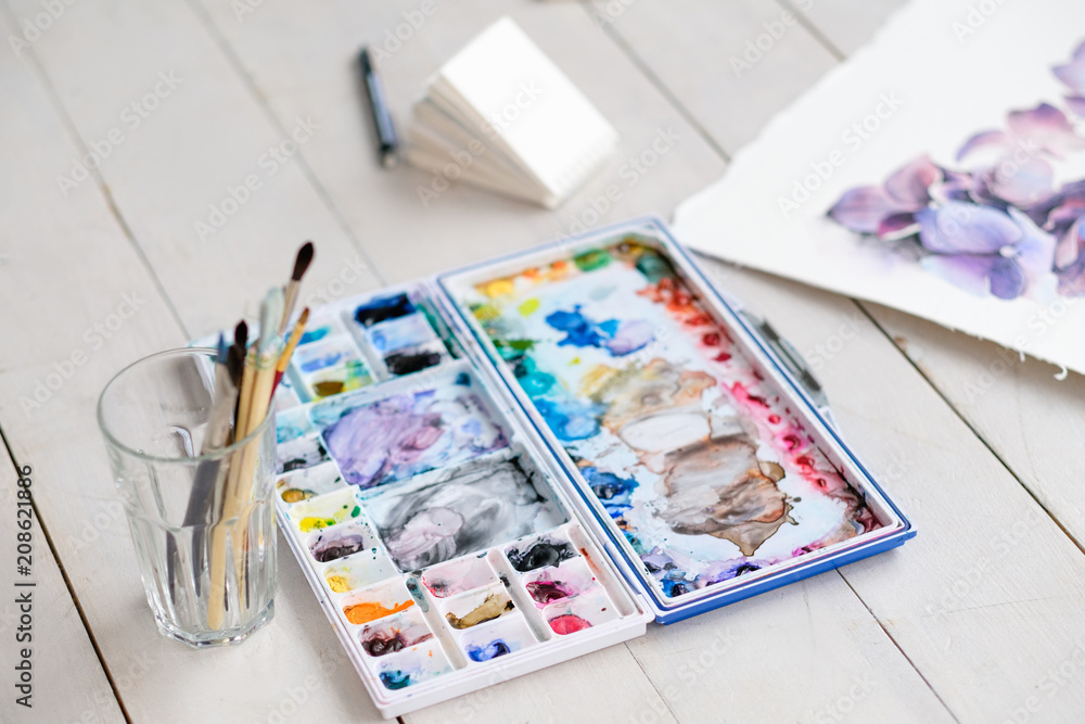 Fototapeta premium painting art classes. drawings creation. color mix. watercolor palette and brushes in a glass