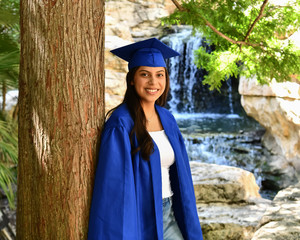 Young Female High School Senior posing for Senior photos in a beautiful park setting