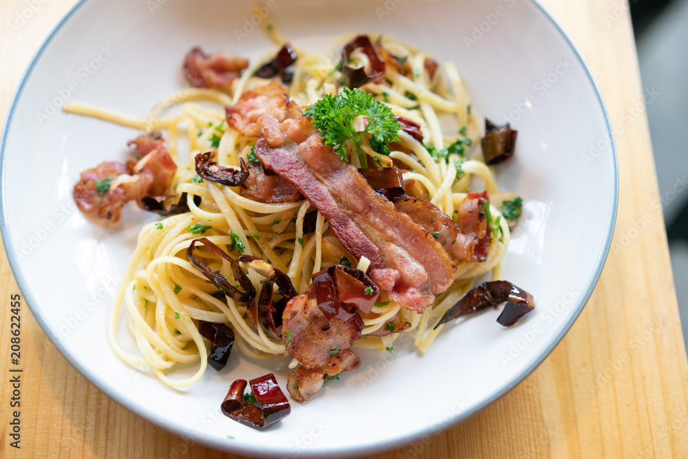 Delicious spaghetti with bacon on wooden table