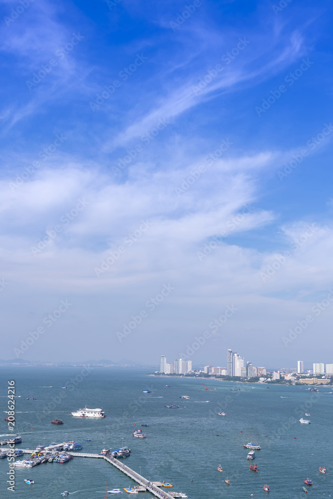 Pattaya cityscape and pattaya sea bay in top view with blue sky and cloud is city is famous tourist Attractions about sea sport and night life entertainment, Chon Buri, Thailand