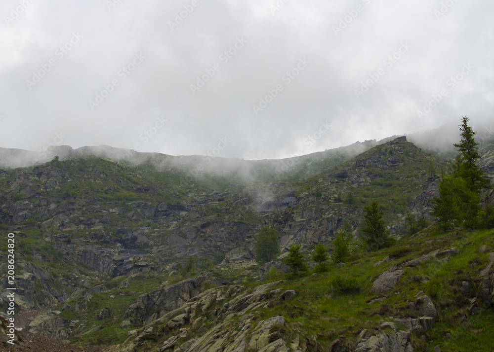 Peak mountains are surrounded by low clouds